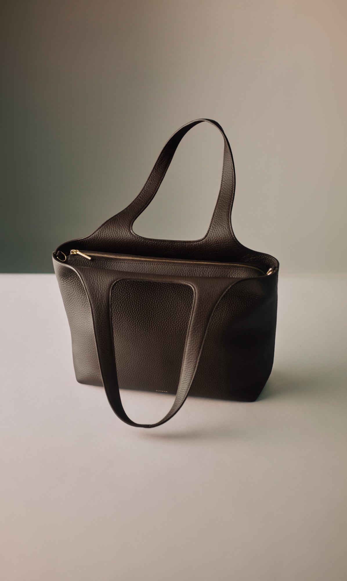 Tote bag with zipper on display surface.