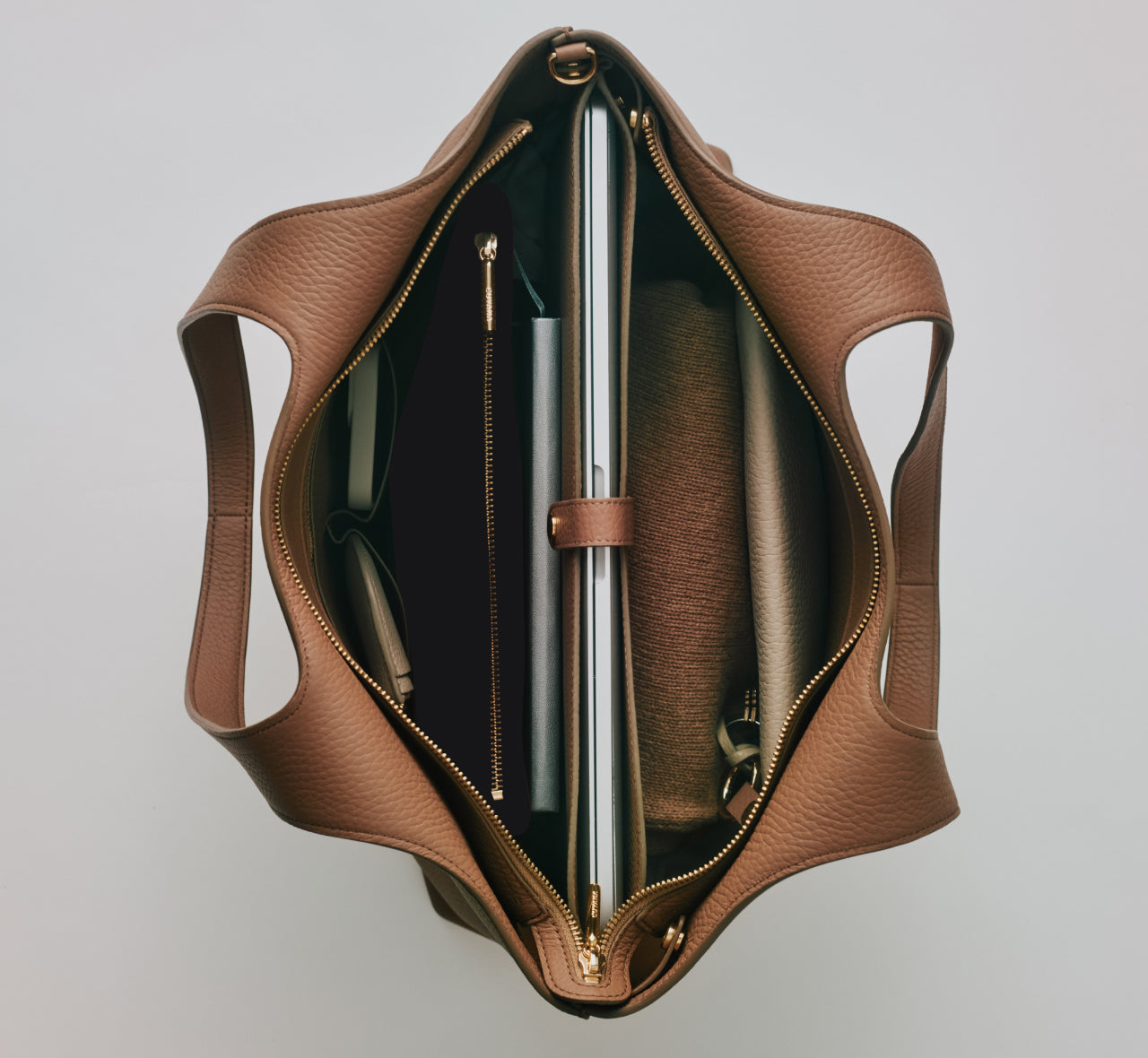 Open tote bag with compartments and contents visible from top view.