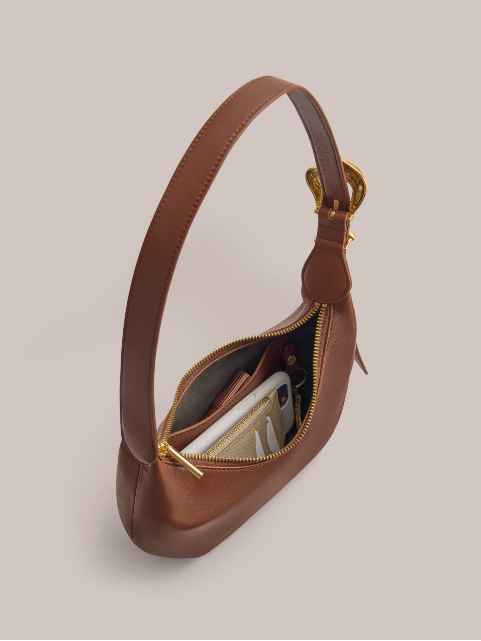 Handbag with open zipper showing contents inside