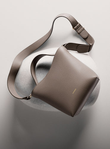 Shoulder bag resting on rounded surface