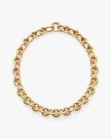 Chain necklace in a circular design placed on a plain background