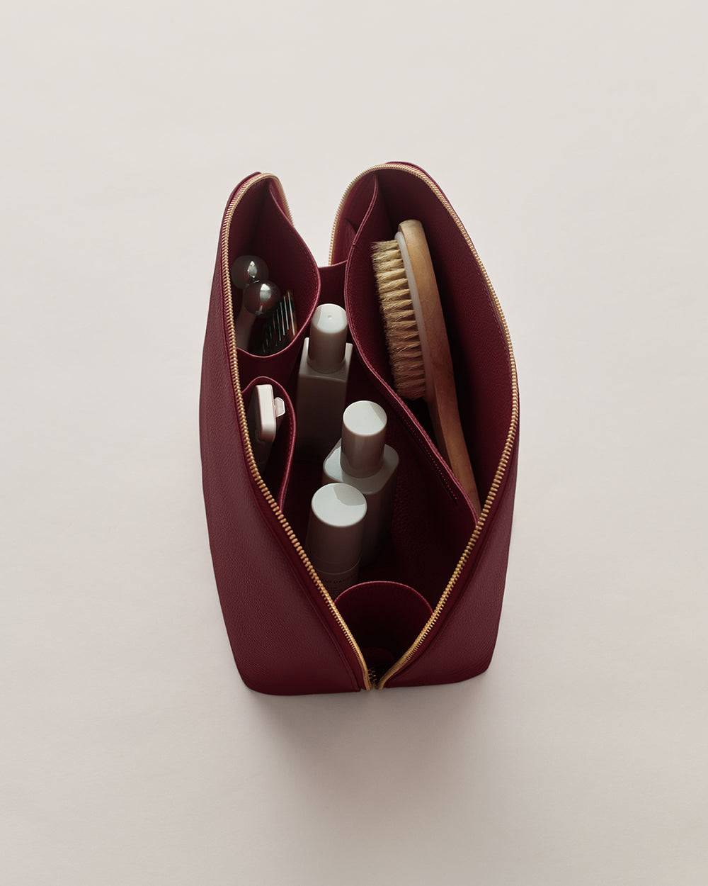 Open toiletry bag with various grooming items inside
