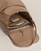 Open backpack with items inside, including a laptop and a small pouch.
