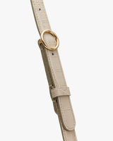 Close-up view of a belt with a circular buckle.