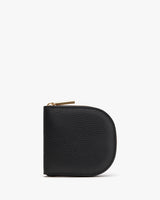 Small rounded zippered wallet standing upright on a plain background.