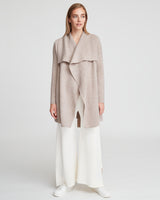 Woman standing in a draped top and flared pants