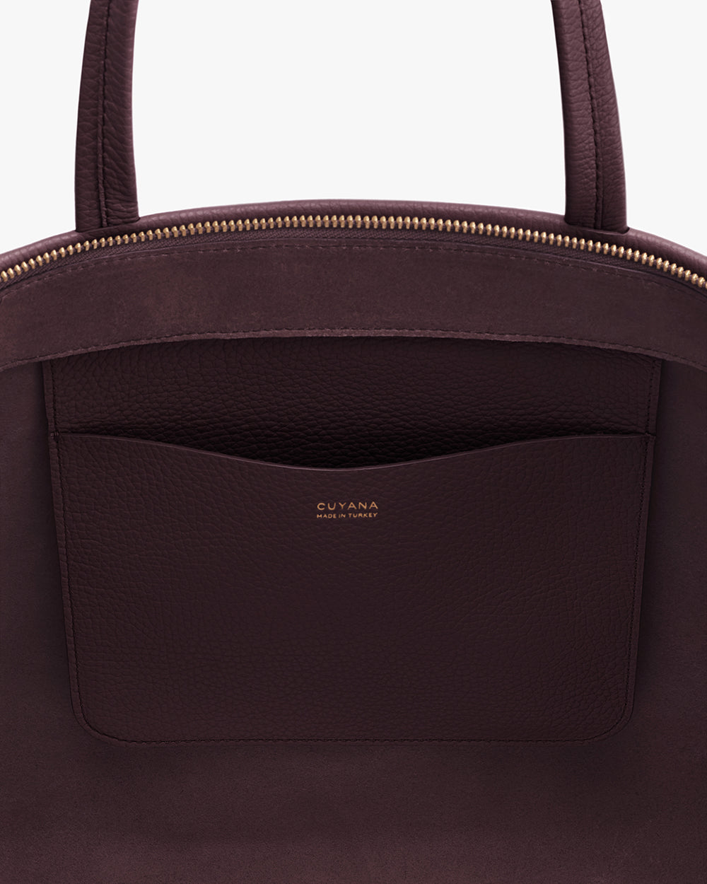 Tote bag with inner pocket and zipper closure.