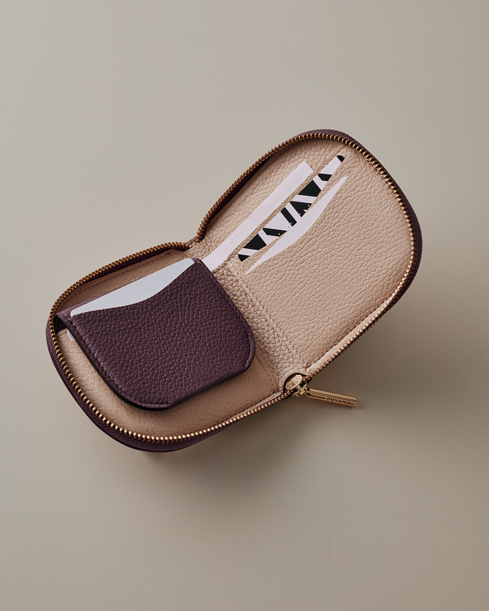 Open zippered wallet with card slots and a small pocket.