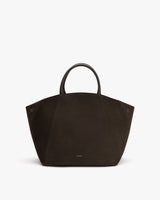 Large tote bag with curved handles on plain background