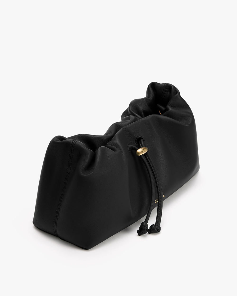 Soft drawstring bag with gathered top lying on a surface.