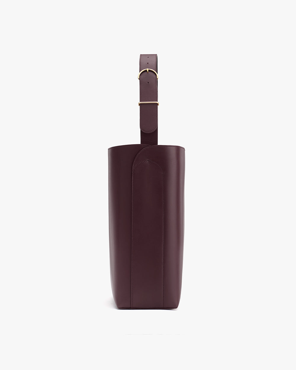 Side view of a tall leather bag with a single strap and buckle.