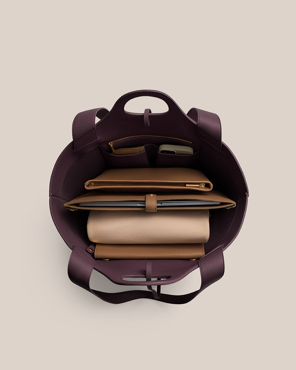 Top view of open handbag with organized contents inside