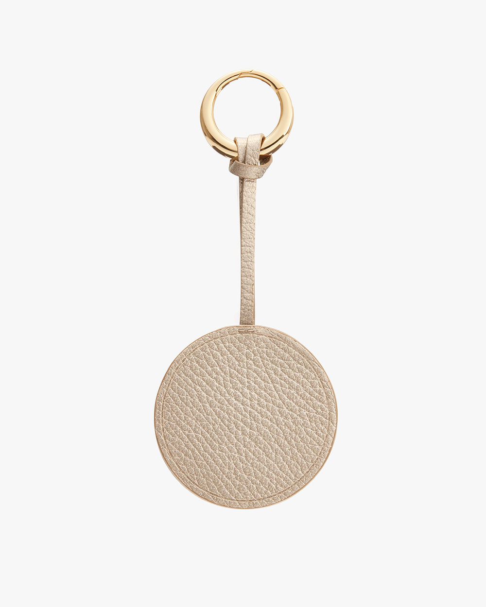 Round keychain with a textured surface and a loop attached to a ring.