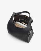 Open handbag with visible contents inside.