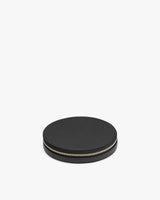 Round object with a zipper on a plain background.