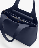 Open handbag with two handles and an inner zipper pocket.