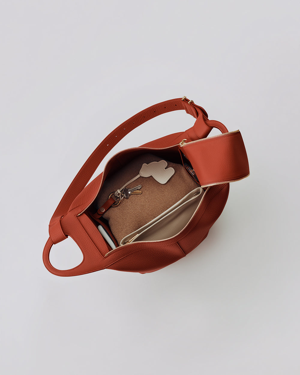 Open bag with items including keys and a pouch inside
