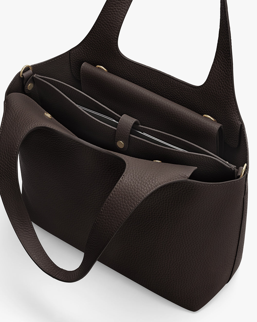 Open handbag with shoulder straps and snap button closures.