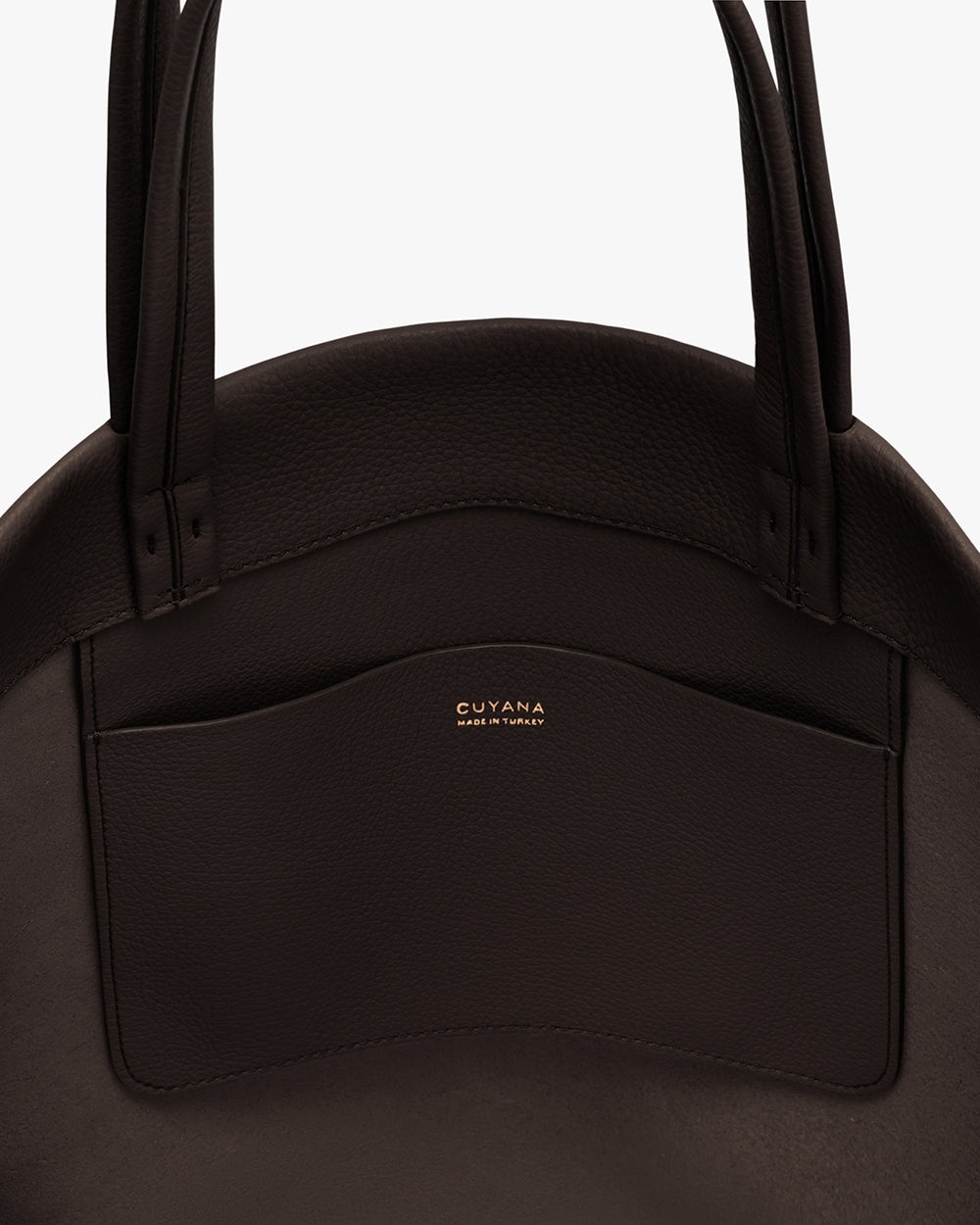 Close-up of a handbag with a visible pocket and handles.