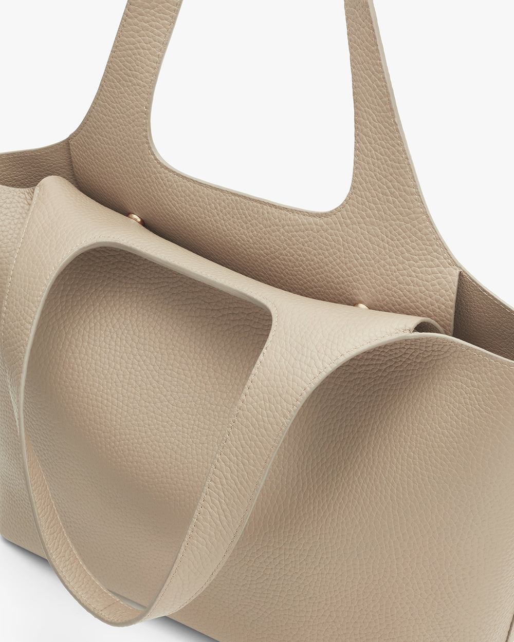 Close-up of a textured handbag with two handles
