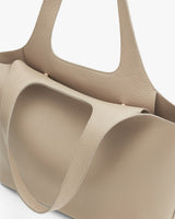 Close-up of a textured handbag with two handles