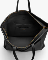 Open travel bag showing inner pocket and zippers.