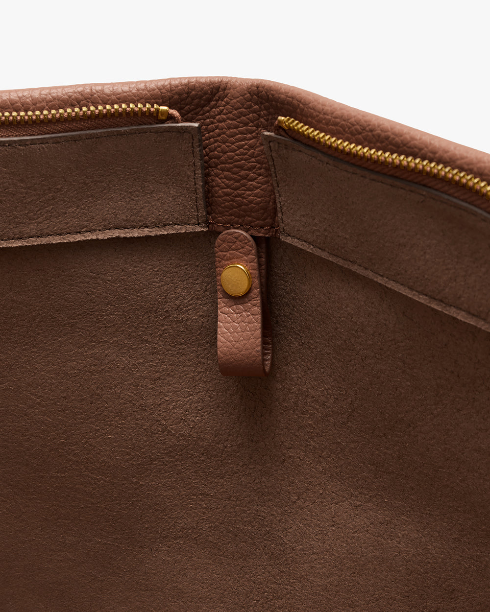 Open leather bag with zipper pockets and snap button strap inside.