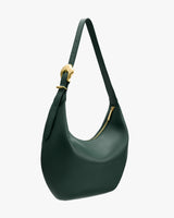 Shoulder bag with a curved shape and a gold buckle on the strap.