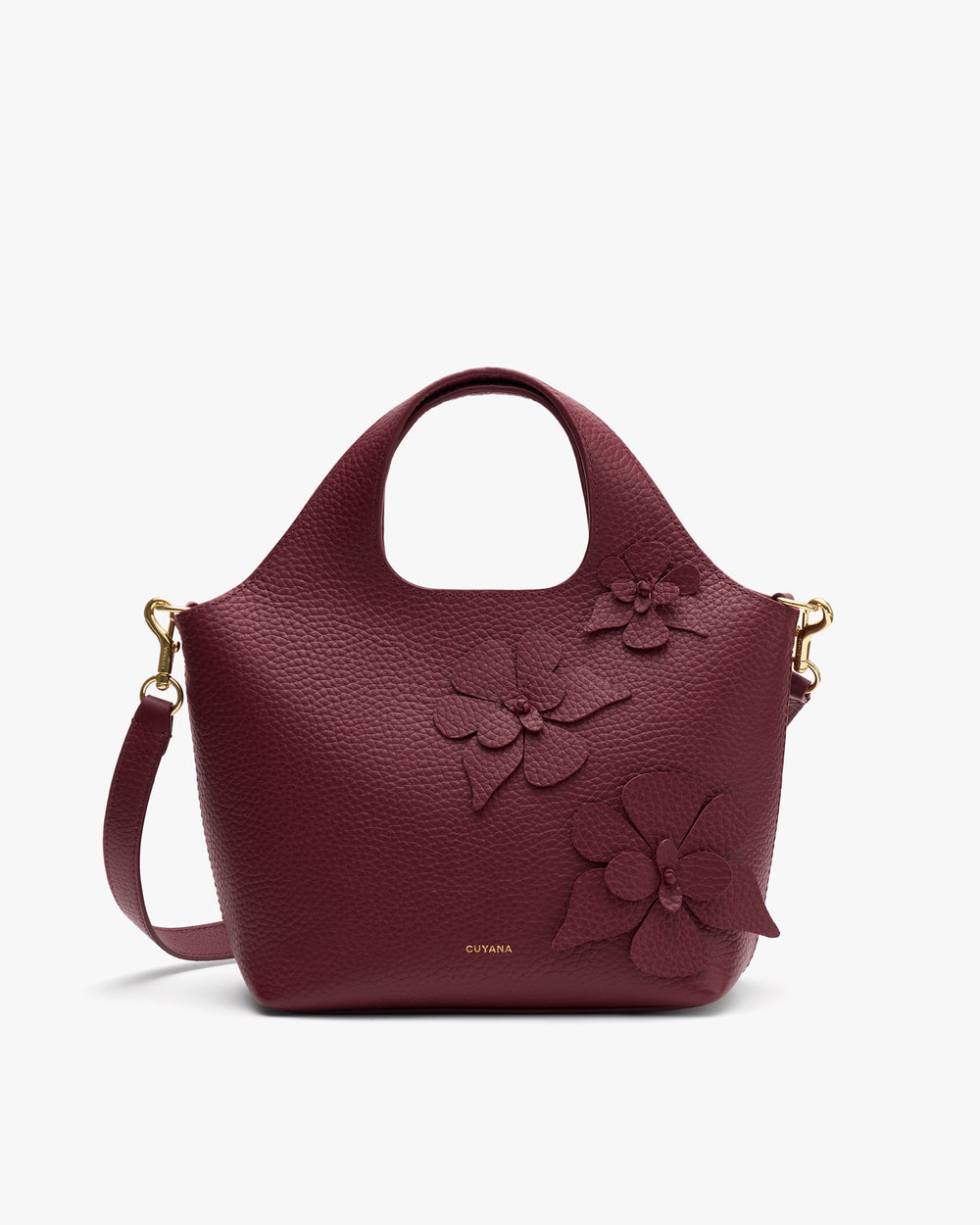 Handbag with a floral detail and round handle.