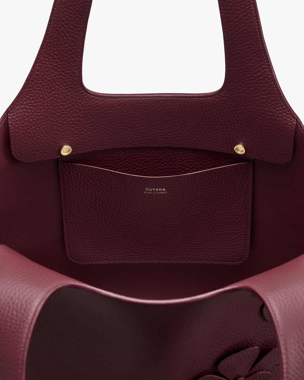 Open leather tote bag with inside pocket and two buttons.
