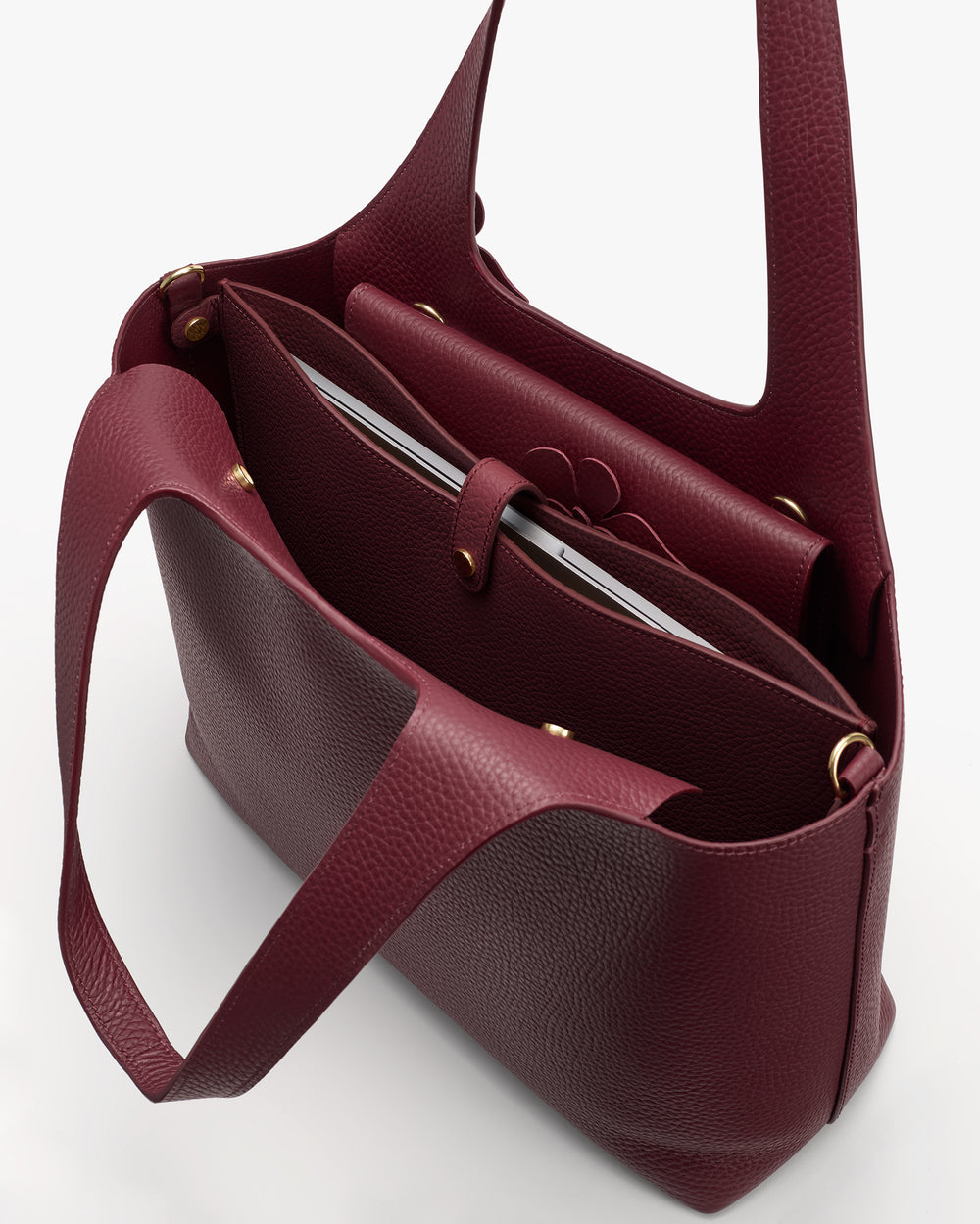 Open tote bag with internal pockets and a visible laptop inside.