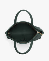 Open handbag with visible zipper and handles viewed from above.