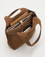 Open handbag with multiple compartments and a laptop inside.