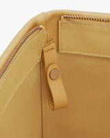 Open tote bag with zipper and buttoned strap detail inside.