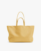 Large tote bag with two handles against plain background.