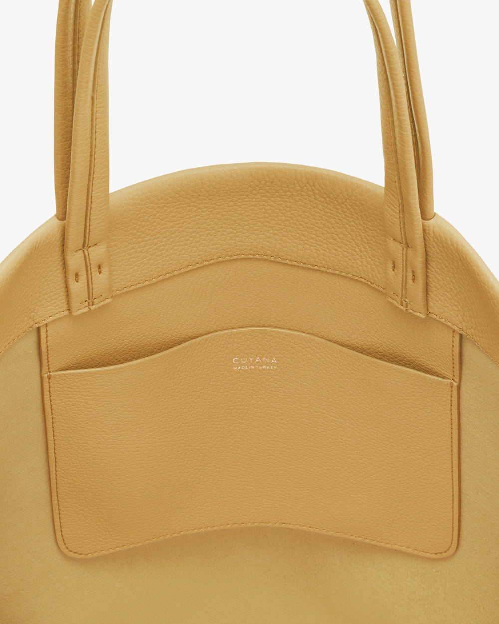 Round bag with handles and an exterior pocket.