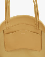 Round bag with handles and an exterior pocket.