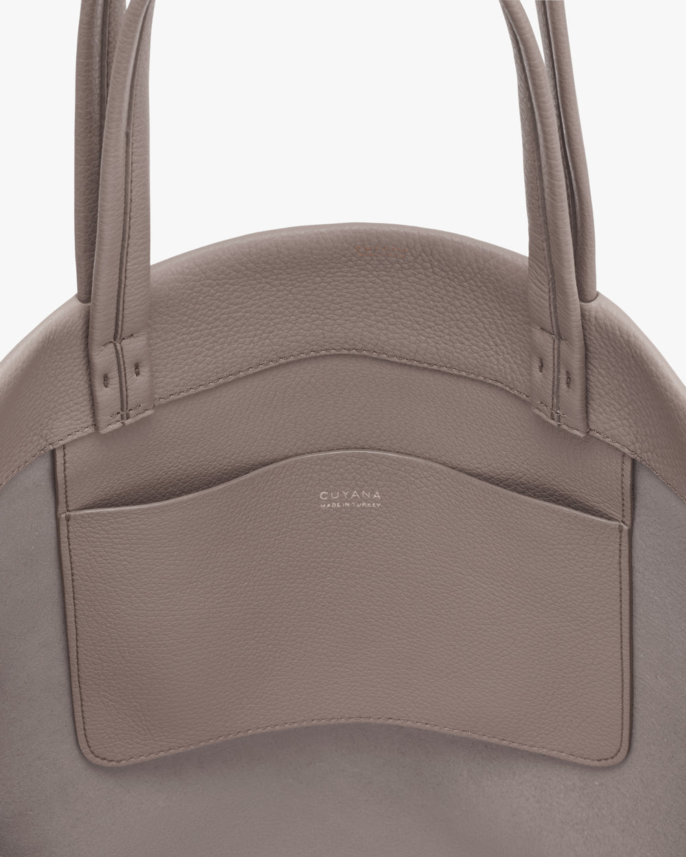 Round handbag with two handles and a pocket on the front.