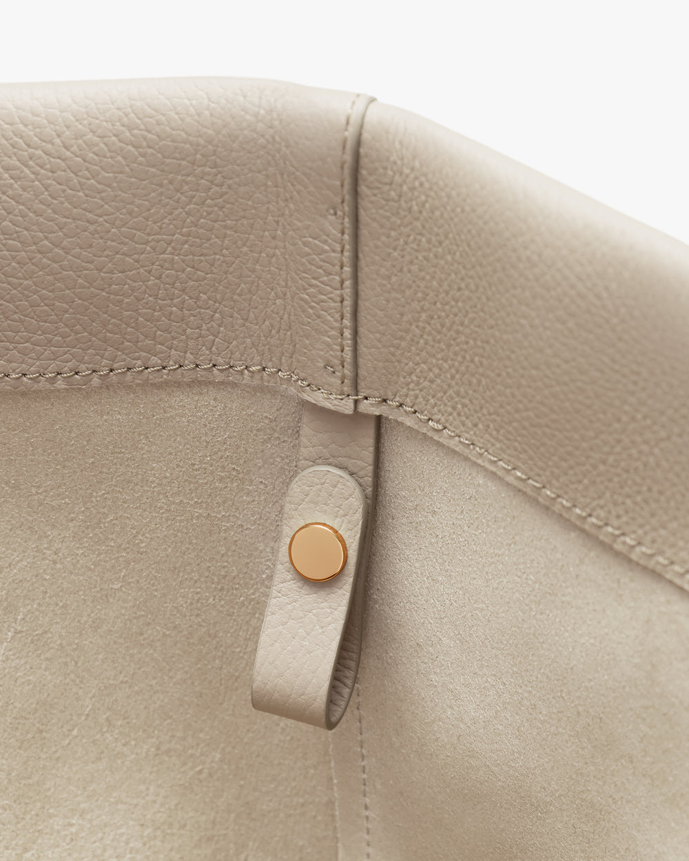 Close-up of a bag interior with a metal snap closure.