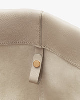 Close-up of a bag interior with a metal snap closure.