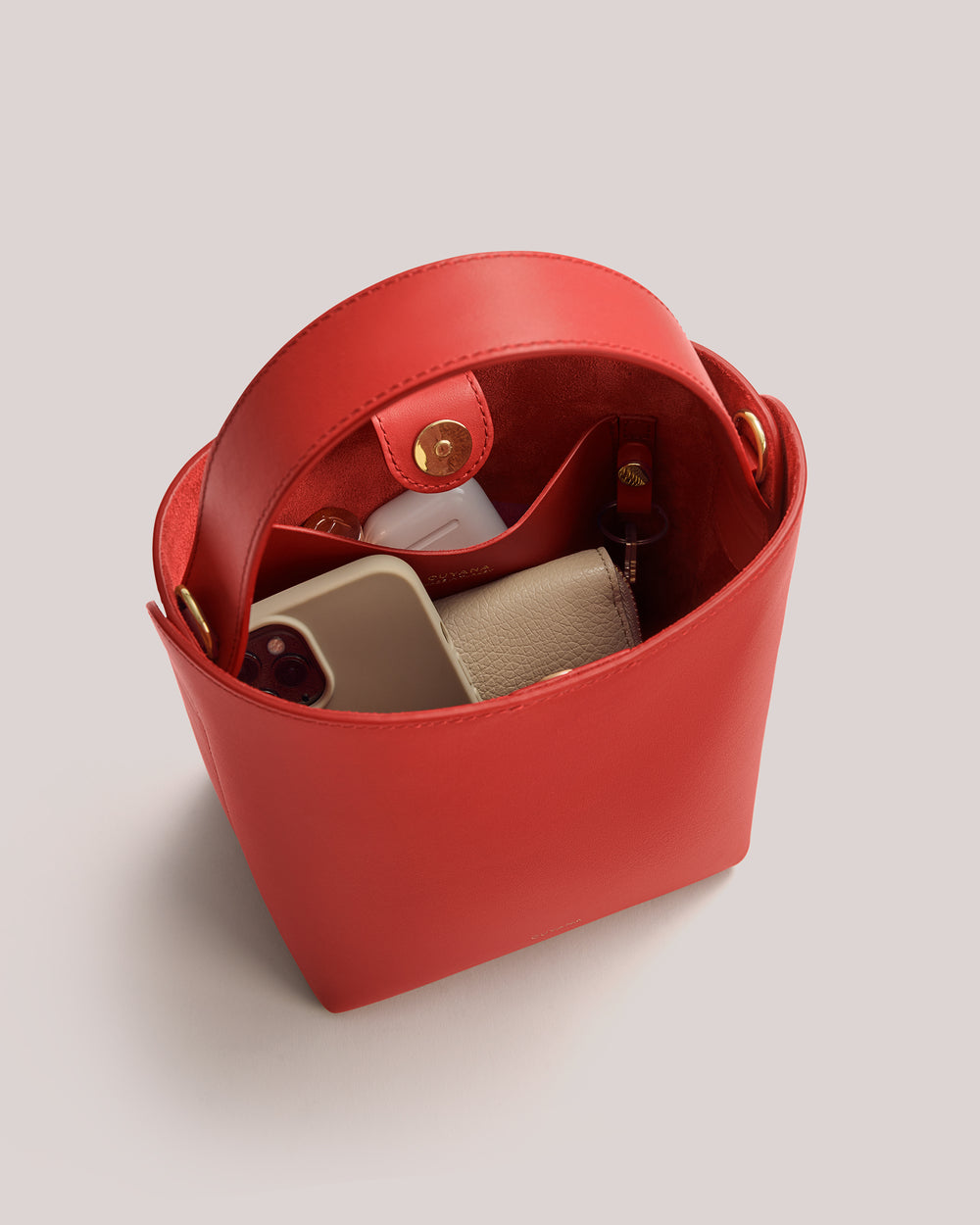 Open handbag with phone and small items inside.