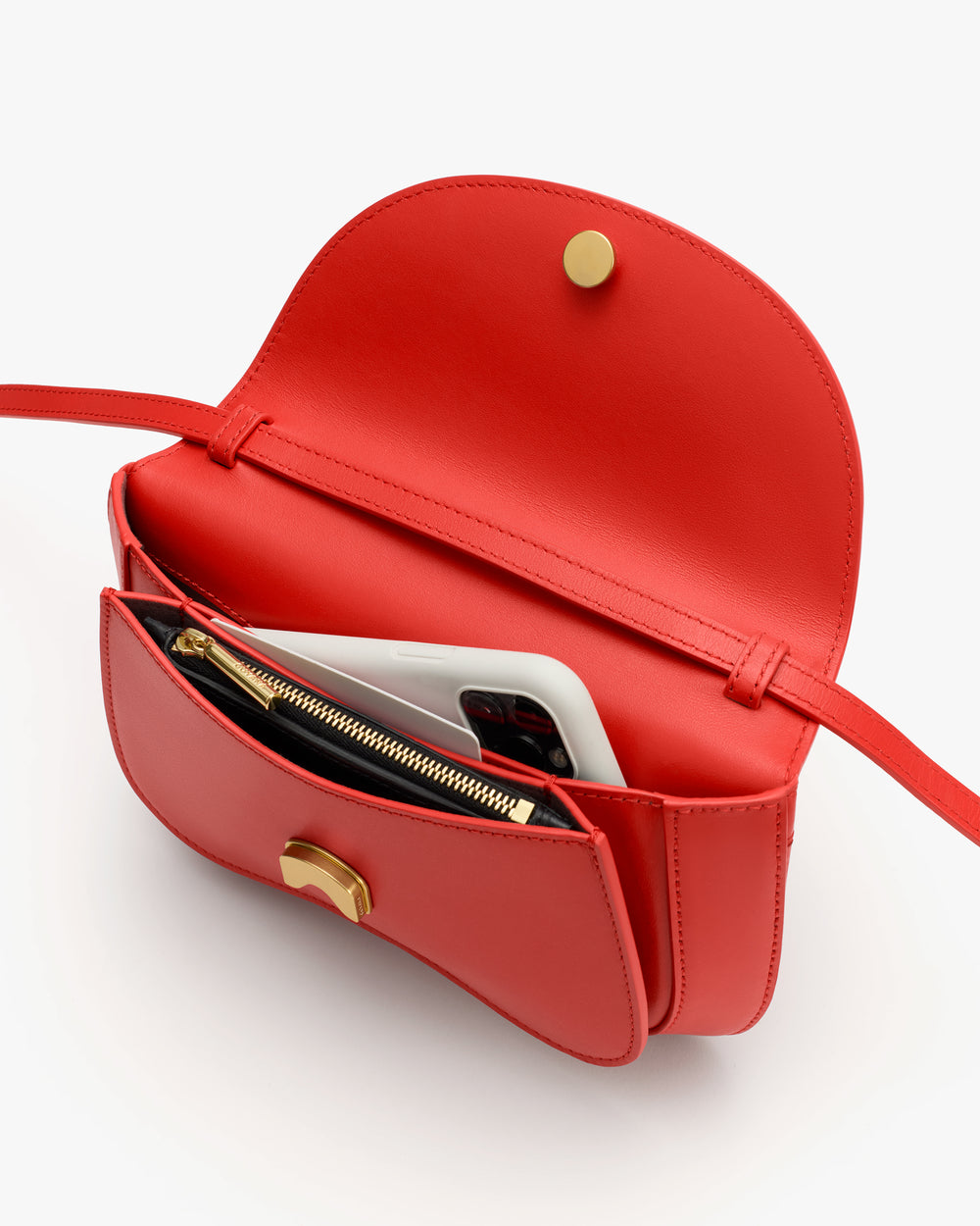 Open handbag with a phone and a zippered pouch inside.