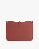Rectangular textured pouch with a flap closure and button details.