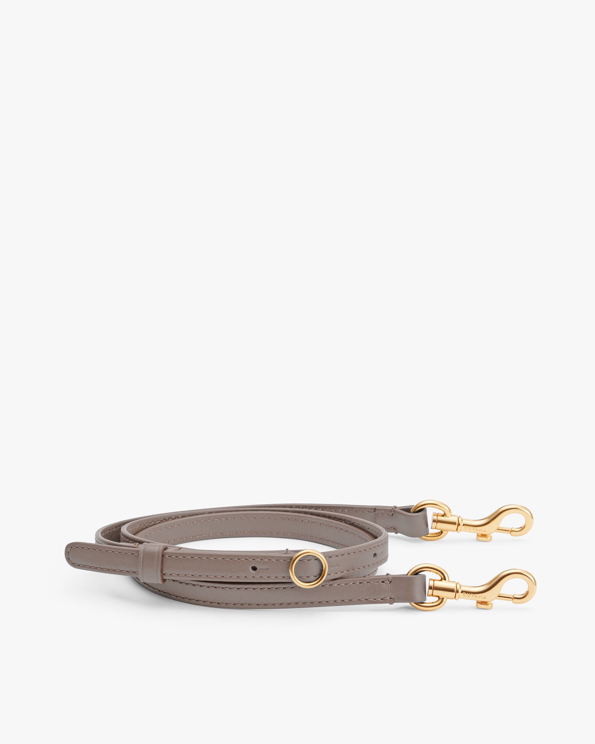 Leather strap with gold clasps laid flat.