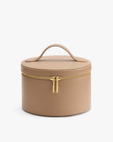 Round textured leather vanity case with a handle and zip closure.
