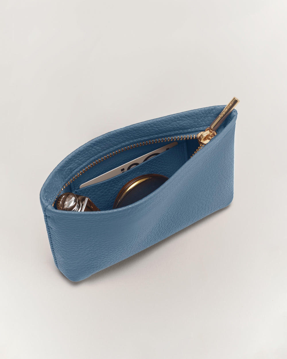 Small zippered pouch with a watch, pen, and sunglasses inside.