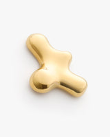 Shiny abstract-shaped metal object on plain background.