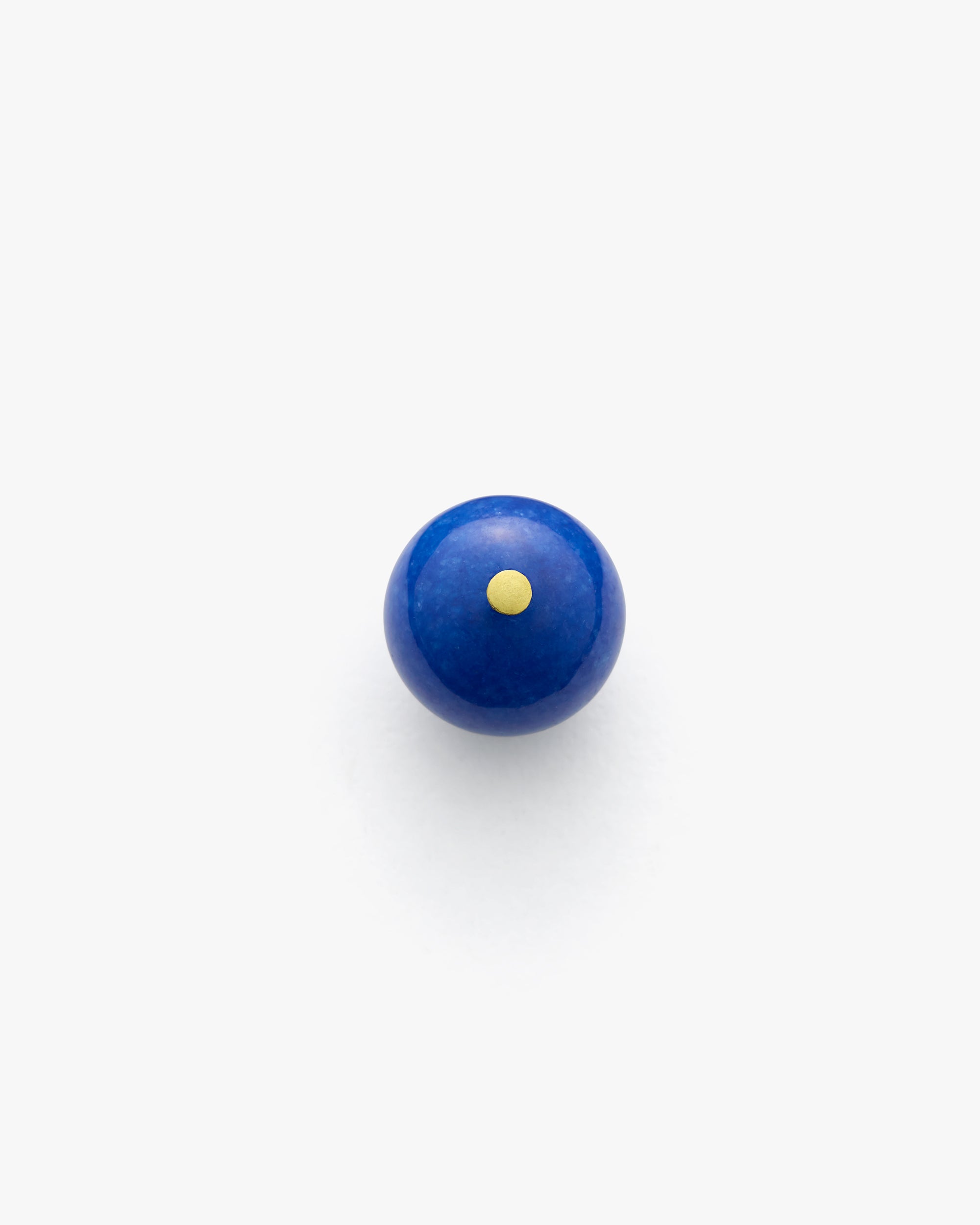 Round object with a small dot centered on top.