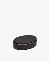 Oval case with a zipper on a plain background.