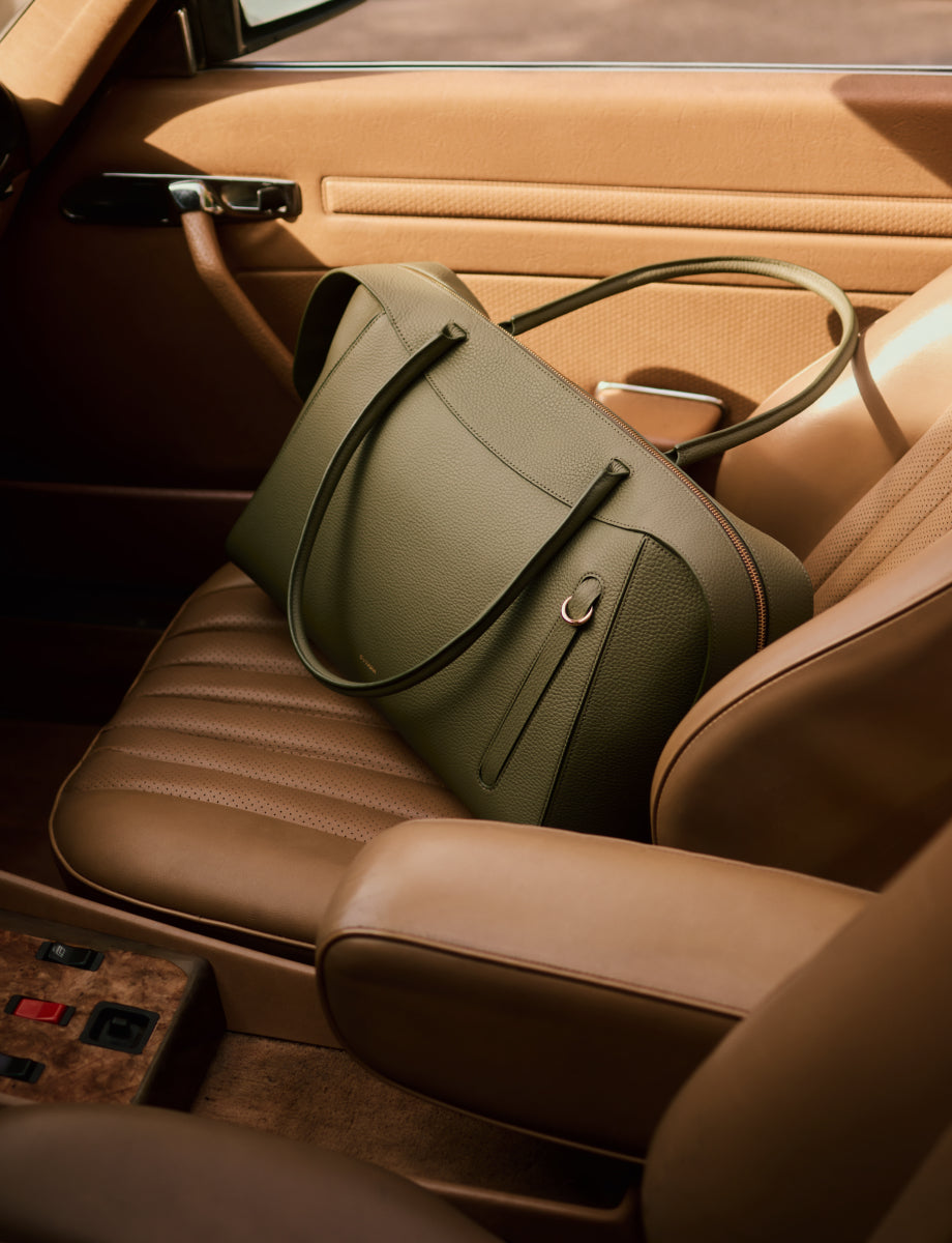 Travel bag on car seat in a vehicle interior.